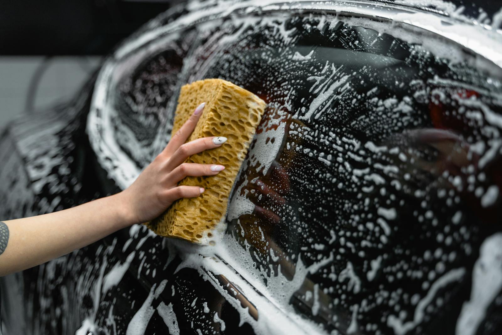 Hand washing a car with foam