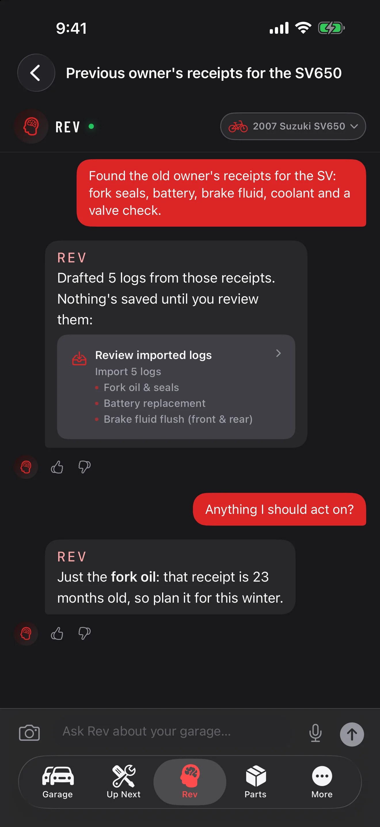 GarageHub on iPhone, Rev chat for a 2007 Suzuki SV650: the owner lists the previous owner’s receipts, and Rev drafts five logs (fork oil and seals, battery, brake fluid flush and more) that are not saved until reviewed, then says the 23-month-old fork oil is the one job to plan this winter.