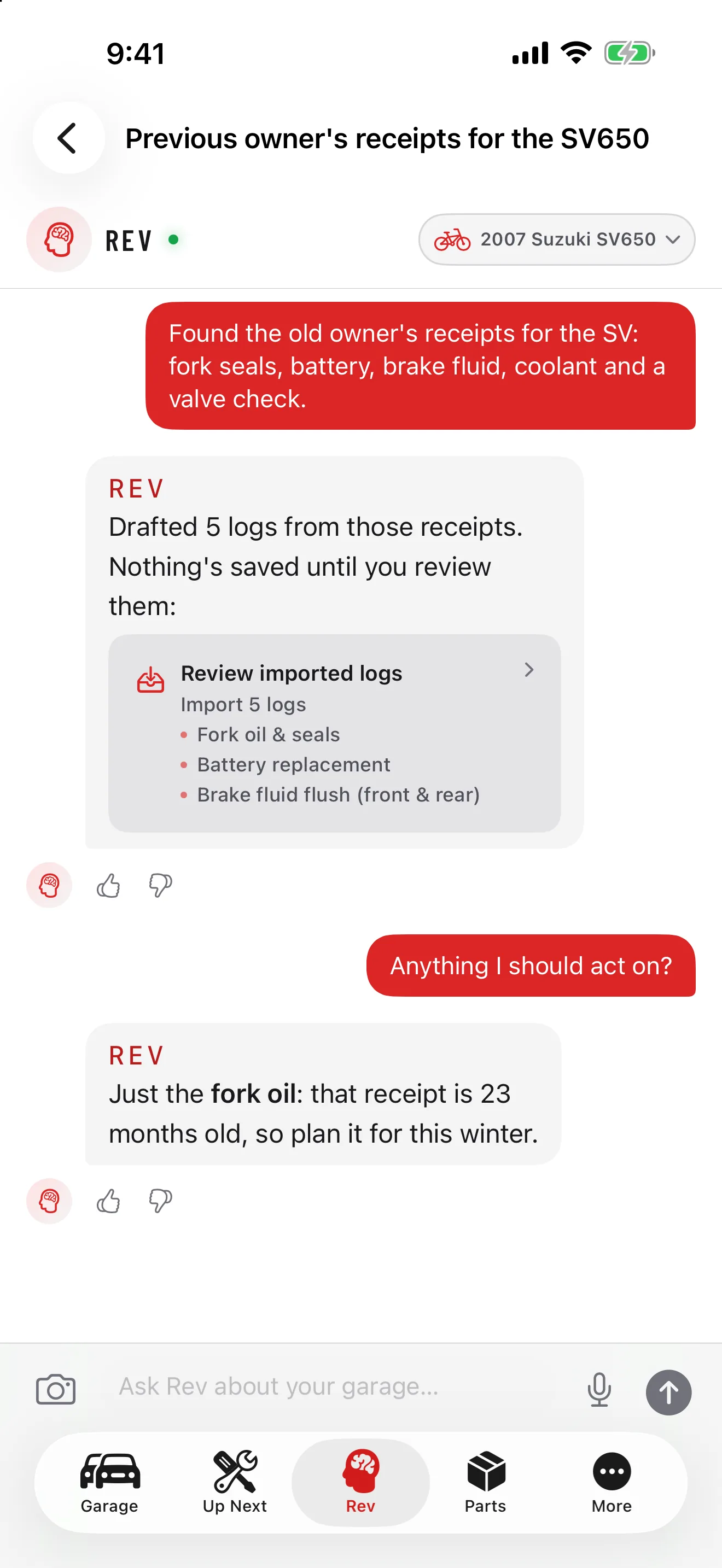 GarageHub on iPhone, Rev chat for a 2007 Suzuki SV650: the owner lists the previous owner’s receipts, and Rev drafts five logs (fork oil and seals, battery, brake fluid flush and more) that are not saved until reviewed, then says the 23-month-old fork oil is the one job to plan this winter.